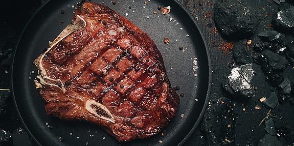 Gut gebratenes Steak auf einem schwarzen Teller
