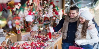 Pärchen kauft auf einem kleinen Design-Weihnachtsmarkt in Wien ein